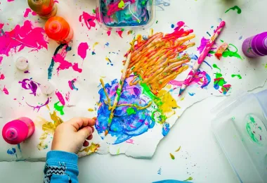 Enfant peignant pendant un atelier d’arts plastiques
